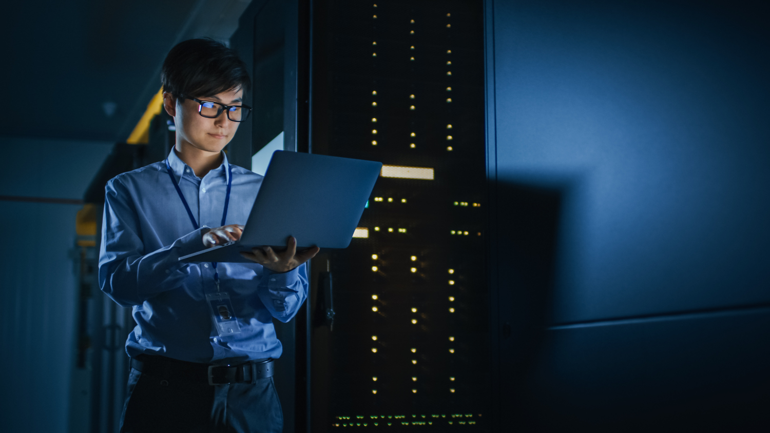 Cybersecurity professional working in a server room.