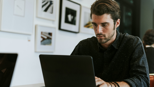 Man Studying ITIL v3 vs. v4 On His Laptop