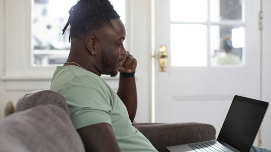 Man Studying The Difference Between ITSM And ITIL On His Laptop