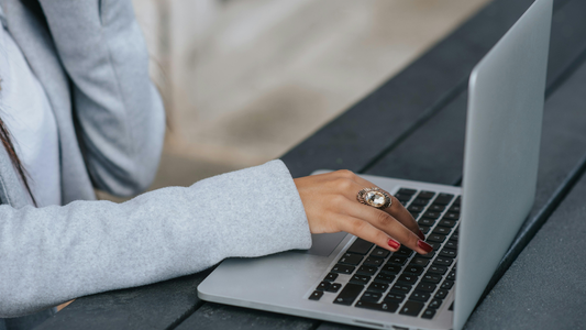 Woman Researching CISSP Course Comparisons On Her Laptop